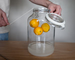 Suspend the lemons in the jar above the Vodka.